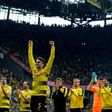 Dortmund's defender Marc Bartra (C) celebrates with his teammates after a German first division football match against Werder Bremen in Dortmund, western Germany, on May 20, 2017