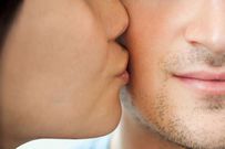 Woman kissing man on cheek
