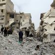 Syrian civil defence volunteers, known as the White Helmets, look for survivors amidst the debris following reported government airstrike on the Syrian town of Ariha, in the northwestern province of Idlib, on February 27, 2017