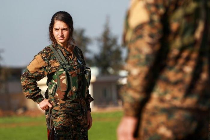 A fighter of the Kurdish Women's Protection Units (YPJ) attends the funeral of an allied Arab fighter on December 21, 2018, among hundreds killed in a four-month-old US-backed offensive against the Islamic State group's last Syria stronghold