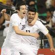 Iran's Mehdi Taremi (R) celebrates with teammate Sardar Azmoun (L) after scoring a goal against Qatar during their World Cup 2018 Asia qualifying football match in Doha on March 23, 2017