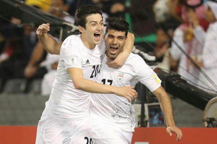 Iran's Mehdi Taremi (R) celebrates with teammate Sardar Azmoun (L) after scoring a goal against Qatar during their World Cup 2018 Asia qualifying football match in Doha on March 23, 2017