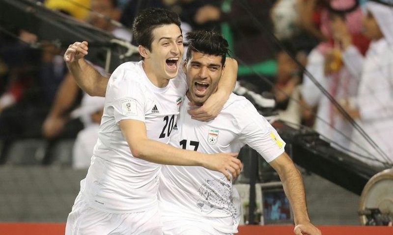 Iran's Mehdi Taremi (R) celebrates with teammate Sardar Azmoun (L) after scoring a goal against Qatar during their World Cup 2018 Asia qualifying football match in Doha on March 23, 2017