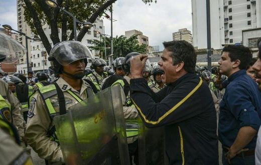 Venezuelan opposition deputy Rafael Guzman (C), confronts National Guard during a protest in front of the National Attorney's General office in Caracas