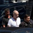 Brazilian businessman Eike Batista (2-R) is escorted as he leaves the Federal Police headquarters after a hearing in Rio de Janeiro, Brazil on February 8, 2017