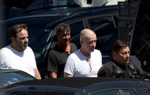 Brazilian businessman Eike Batista (2-R) is escorted as he leaves the Federal Police headquarters after a hearing in Rio de Janeiro, Brazil on February 8, 2017