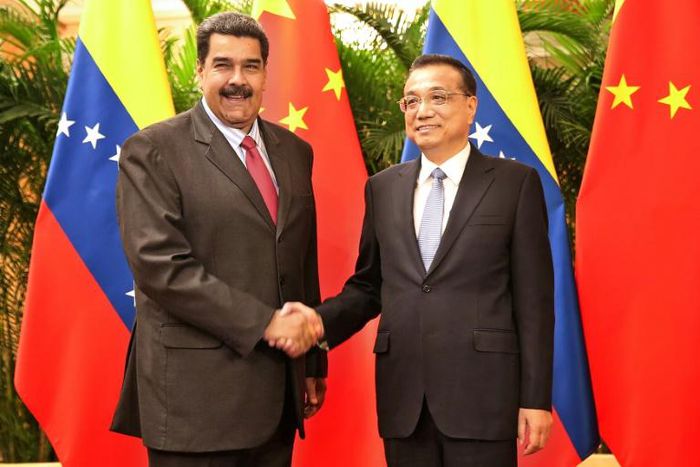 Venezuelan President Nicolas Maduro shakes hands with Chinese Premier Li Keqiang last year. China said Friday it was against forcefully sending "so-called humanitarian assistance" to the crisis-wracked country