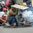 Opposition demonstrators clash with police during a protest in Caracas