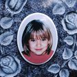 The portrait of murder victim Peggy Knobloch is seen on a memorial stone at the cemetery in Nordhalben near Kronach, southern Germany