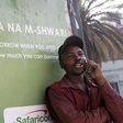 A man on phone next to an M-Shwari branded bus termini in Nairobi. The M-Shwari mobile banking service is set to be launched in Rwanda by April next year before rolling out to West Africa as it spreads its wings across Africa.