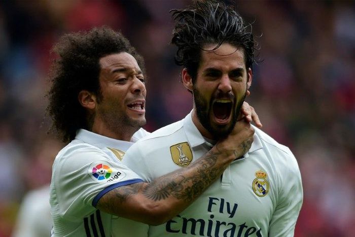 Real Madrid's Isco (R) is congratulated by Marcelo after scoring a goal during the Spanish league football match against Real Sporting de Gijon on April 15, 2017