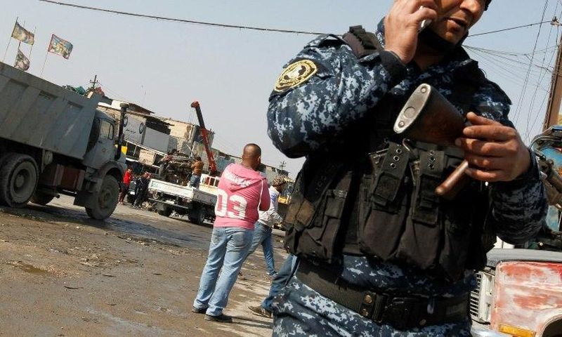 An Iraqi policeman guards the site where a car bomb exploded in an industrial area of south Baghdad on February 14, 2017, killing at least four people
