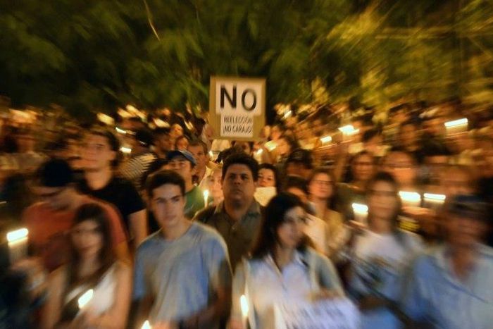 Thousands of demonstrators rally in front of the Congress in Asuncion on April 3, 2017 to protest against a bid to lift a ban on President Horacio Cartes that would allow him to be reelected