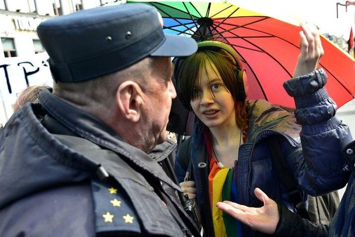 Russian riot police detain a gay rights activist at a May Day rally in Saint Petersburg