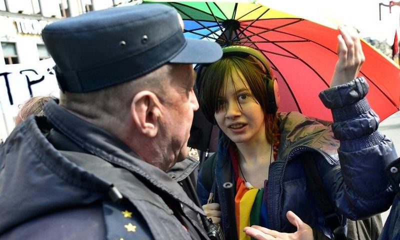 Russian riot police detain a gay rights activist at a May Day rally in Saint Petersburg