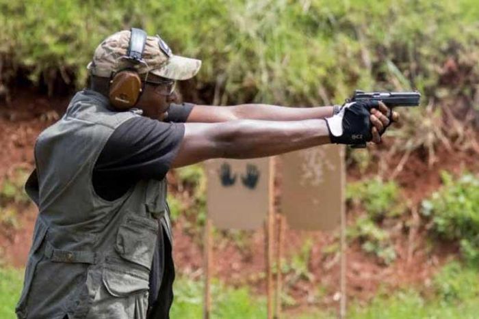 Man hunt for foreigner captured on video threatening to shoot security guard