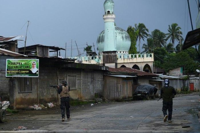 Government troops patrol a deserted street near the position of Islamic militants in Marawi, on the southern island of Mindanao on May 27, 2017