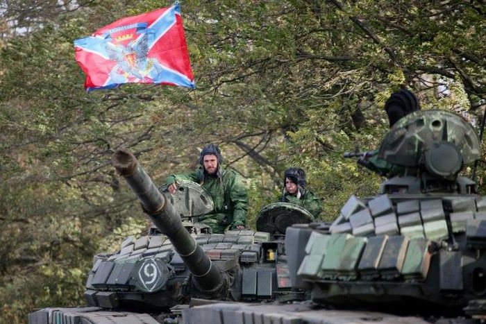Pro-Russian separatists soldiers withdraw their tanks from position near town of Novoazovsk in Donetsk region on October 21, 2015
