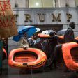 People carry rafts, signifying the struggle of refugees, as they march on Wall Street during a protest against the Trump administration's proposed travel ban and refugee policies, in New York, on March 28, 2017