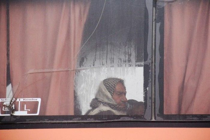 A Syrian man aboard an evacuation bus from government-held Fuaa and Kafraya arrives at a marshalling point in rebel-held Rashidin on April 14, 2017