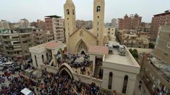 A general view shows people gathering outside the Mar Girgis Coptic Church in the Nile Delta City of Tanta, 120 kilometres (75 miles) north of Cairo, after a bomb blast struck worshippers gathering to celebrate Palm Sunday on April 9, 2017