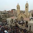 A general view shows people gathering outside the Mar Girgis Coptic Church in the Nile Delta City of Tanta, 120 kilometres (75 miles) north of Cairo, after a bomb blast struck worshippers gathering to celebrate Palm Sunday on April 9, 2017
