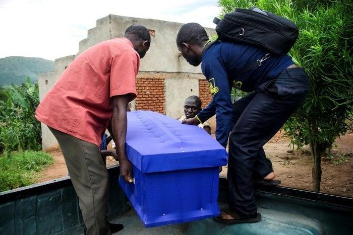 Relatives prepare to bury a guard of King Charles Wesley Mumbere of the Rwenzururu kingdom after clashes with security forces leave scores dead