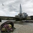 A single bunch of flowers lies on a wall on the northern bank of the River Thames close to London Bridge on June 4, 2017