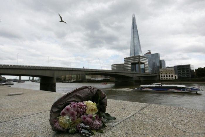 A single bunch of flowers lies on a wall on the northern bank of the River Thames close to London Bridge on June 4, 2017