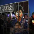 A poster shows Park Geun-Hye behind bars, at a rally in Seoul on March 11, 2017