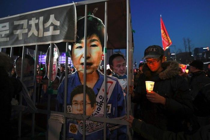 A poster shows Park Geun-Hye behind bars, at a rally in Seoul on March 11, 2017