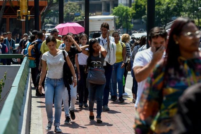 Commuters unable to use the subway due to a partial power cut, flock to the streets in Caracas