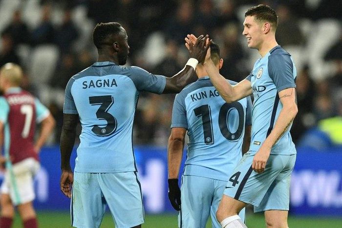 Manchester City's John Stones (R) celebrates with teammate Bacary Sagna after scoring a goal during their English FA Cup 3rd round match against West Ham United, at the London Stadium, on January 6, 2017