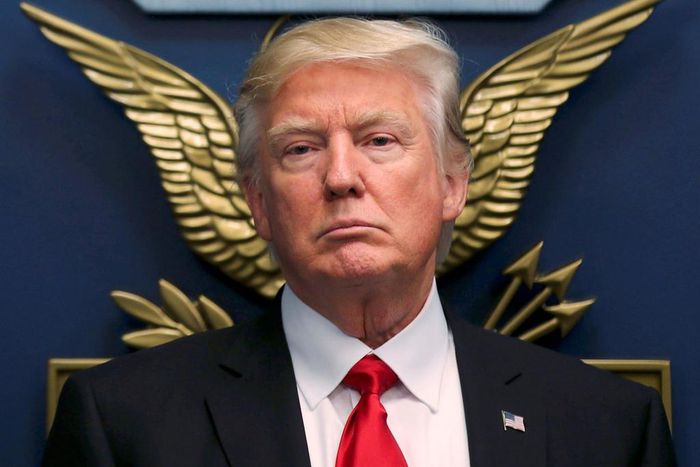 U.S. President Donald Trump (C) signs an Executive Order establishing extreme vetting of people coming to the United States after attending a swearing-in ceremony for Defense Secretary James Mattis.