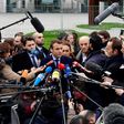 French presidential election candidate for the En Marche! movement Emmanuel Macron (C) speaks to journalists after a meeting with German Chancellor Angela Merkel in the Chancellery in Berlin on March 16, 2017