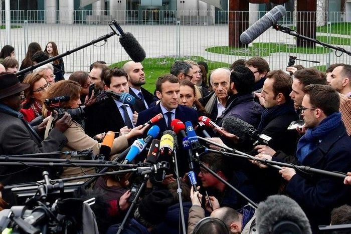 French presidential election candidate for the En Marche! movement Emmanuel Macron (C) speaks to journalists after a meeting with German Chancellor Angela Merkel in the Chancellery in Berlin on March 16, 2017