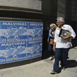 People walk past posters that read 'The Malvinas (Falklands Islands) are Argentine' in downtown Buenos Aires, on March 31, 2016