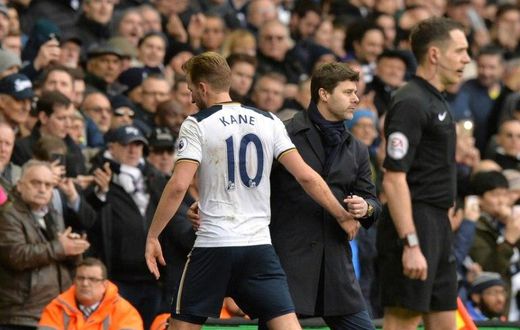 Tottenham Hotspur's Harry Kane (L) is greeted by team manager Mauricio Pochettino as he leaves the pitch substituted during their English Premier League match against Stoke City, at White Hart Lane in London, on February 26, 2017