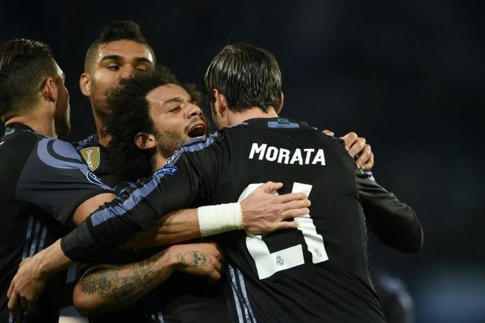 Real Madrid's Alvaro Morata (R) celebrates a goal with teammates at the end of their UEFA Champions League football match agaisnt Granada on March 7, 2017 at the San Paolo stadium in Naples
