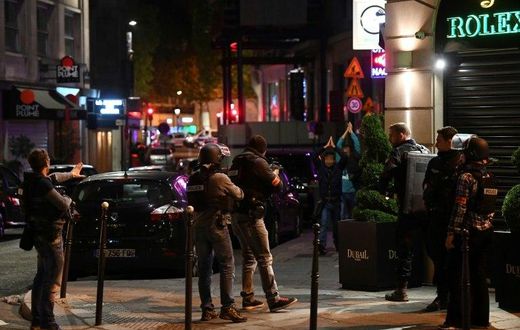 Police check passersby near the Champs Elysees in Paris after a shooting which left one officer dead and two wounded