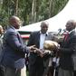 File image of DP Ruto presenting money at a past fundraiser in Kisii