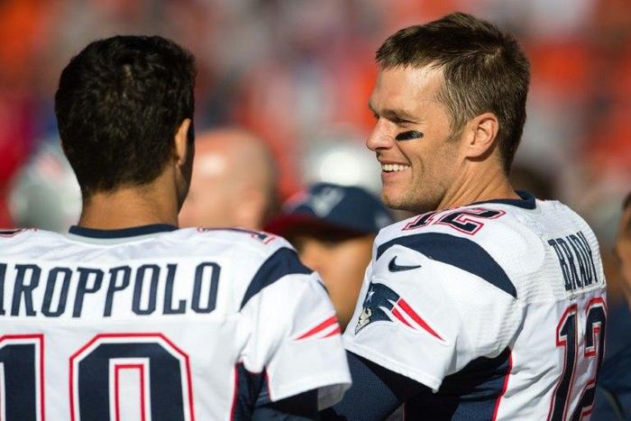Quarterbacks Jimmy Garoppolo and Tom Brady of the New England Patriots talk on the sidelines against the Cleveland Browns, in Cleveland, Ohio, on October 9, 2016