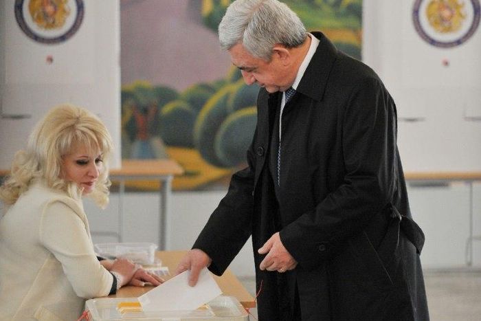 Armenian President Serzh Sarkisian casts his ballot in elections observers say were marred by allegations of fraud