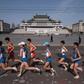 Competitors run through Kim Il-Sung square during the Pyongyang Marathon, on April 9, 2017