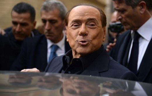 Former Italian prime minister Silvio Berlusconi leaves after voting in a referendum on constitutional reforms in Rome on December 4, 2016