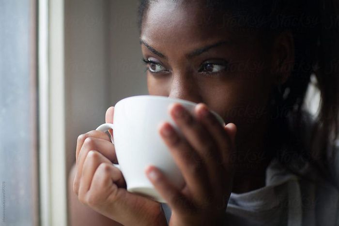 Black woman drinking tea [Stocksy]