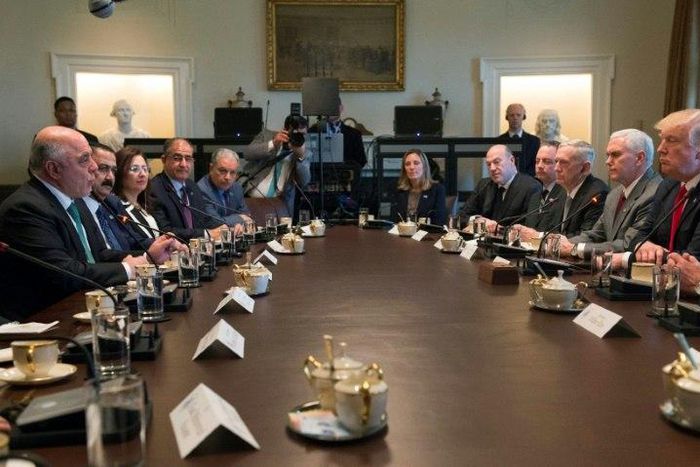 US President Donald Trump listens while Iraqi Prime Minister Haider Al-Abadi speaks during their meeting in the Cabinet Room in the White House on March 20, 2017