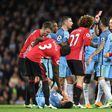 Referee Martin Atkinson (2R) shows the red card to send Manchester United's midfielder Marouane Fellaini (C) off after an altercation with Manchester City's striker Sergio Aguero (3L floor) during the Premier League football match April 27, 2017
