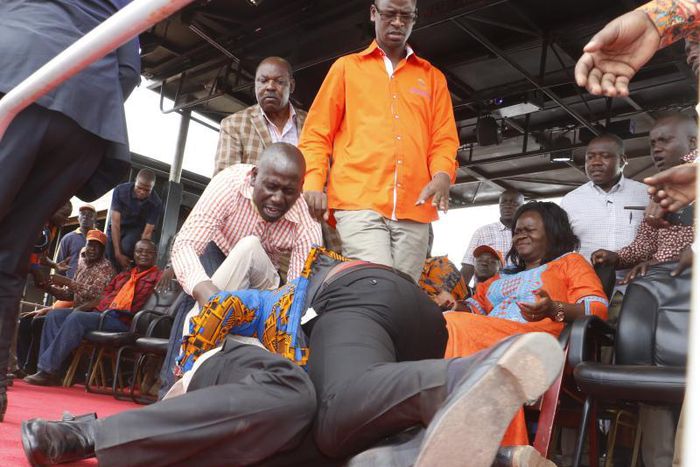 Homa Bay Town MP Peter Kaluma and his rival Washington Ogaga wrestle each other to the ground before ODM supporters and party leaders at the Homa Bay Stadium on November 27, 2016.
