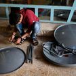 A young Iraqi prepares satellite dishes for sale at a market in east Mosul on April 15, 2017. Since Iraqi forces recaptured the sector from the Islamic State group in January, business has surged